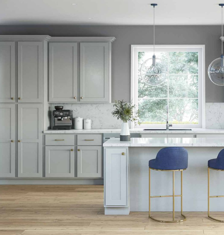 Light gray shaker kitchen cabinets with quartz island